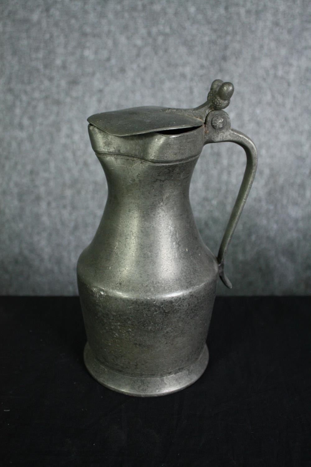 A set of six 19th century graduating pewter lidded jugs. H.27cm. (largest) - Image 2 of 6