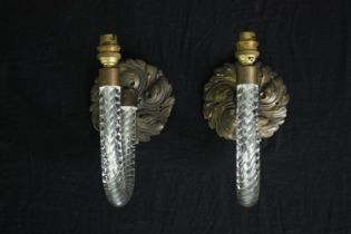 A pair of cane glass wall sconces on scrolling foliate bronze back plates. H.25cm. (each)