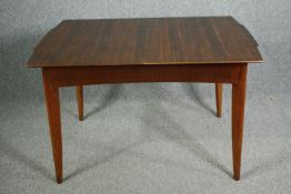 A mid century Waring and Gillow Ltd dining table. H.75 W.122 D.84cm. (The central leaf is missing
