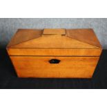 A Regency satinwood caddy of sarcophagus form with fitted interior. H.17 W.30 D.15cm.