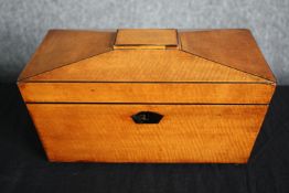 A Regency satinwood caddy of sarcophagus form with fitted interior. H.17 W.30 D.15cm.