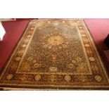 A Persian carpet with central flowerhead medallion on a midnight ground within naturalistic