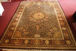 A Persian carpet with central flowerhead medallion on a midnight ground within naturalistic