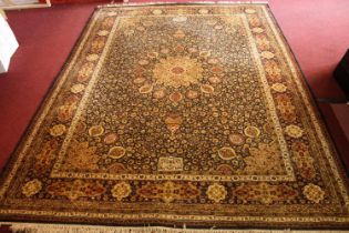 A Persian carpet with central flowerhead medallion on a midnight ground within naturalistic