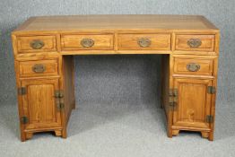 A Chinese elm three part pedestal desk of slightly curved outline. H.86 W.148 D.70cm.