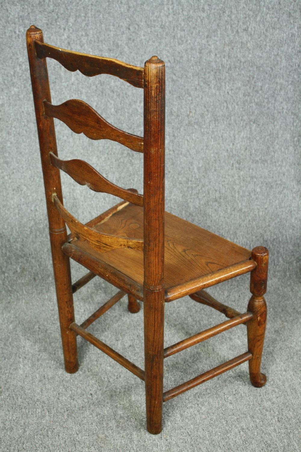 A pair of 18th century elm Lancashire ladderback dining chairs. - Image 4 of 7
