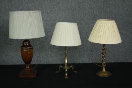 A collection of three table lamps, turned wood and brass. H.39cm. (largest).