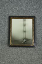 A 19th century wall mirror in mahogany and carved giltwood frame. H.49 W.42cm.