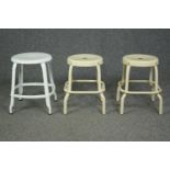 A pair of metal industrial style stools and another similar. H.46cm. (largest)