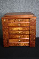 A burr elm specimen or vanity chest with rising mirror to the top and hinged locking stile side