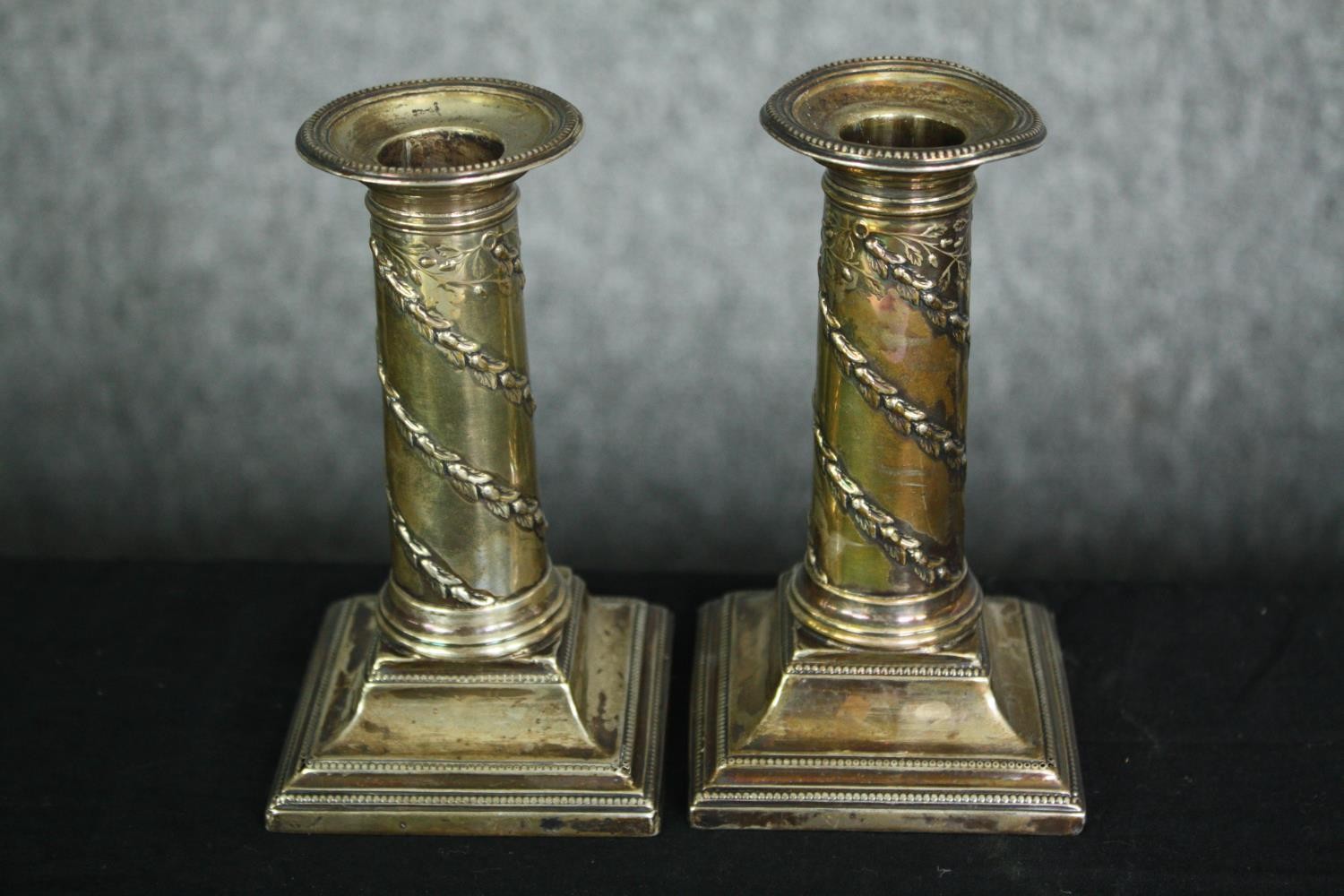 A collection of hallmarked silver to include a pair of filled candlesticks, a pair of salts, and a - Image 3 of 18