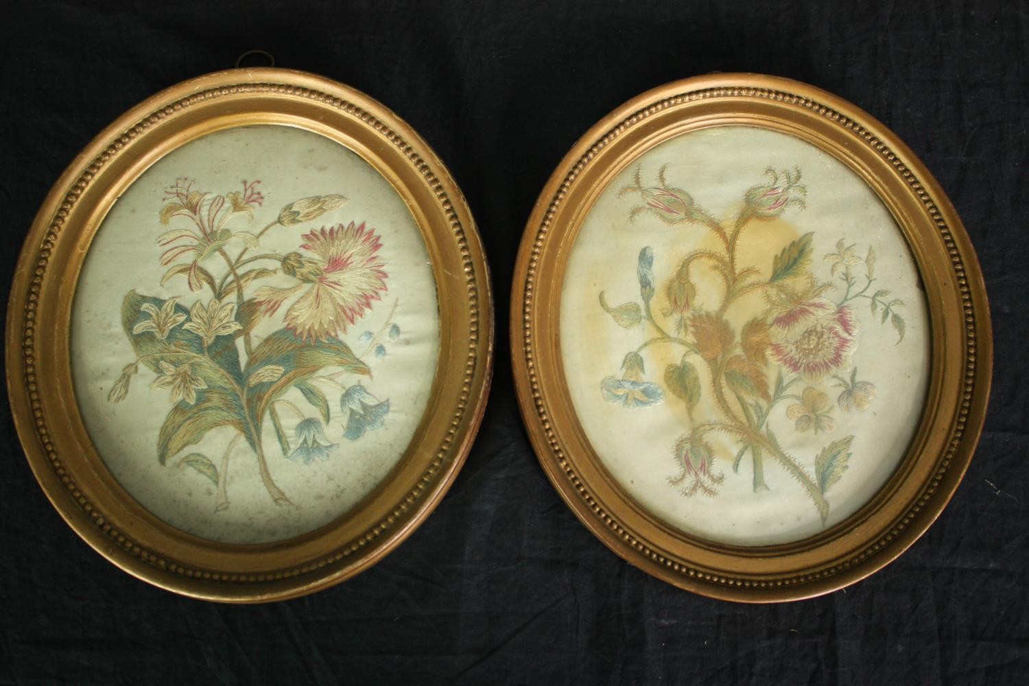 A pair of 19th century woolwork embroideries, honeysuckle, carnations and bluebells, framed and