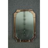 An Art Deco wall mirror with peach glass borders. H.77 W.51cm.