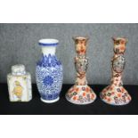 A Delft tea caddy, a Chinese blue and white vase and a pair of Imari candlesticks. H.23cm. (largest)