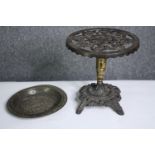 A 19th century brass and iron trivet in the form of a table and an embossed dish. H.26 Dia.26cm. (