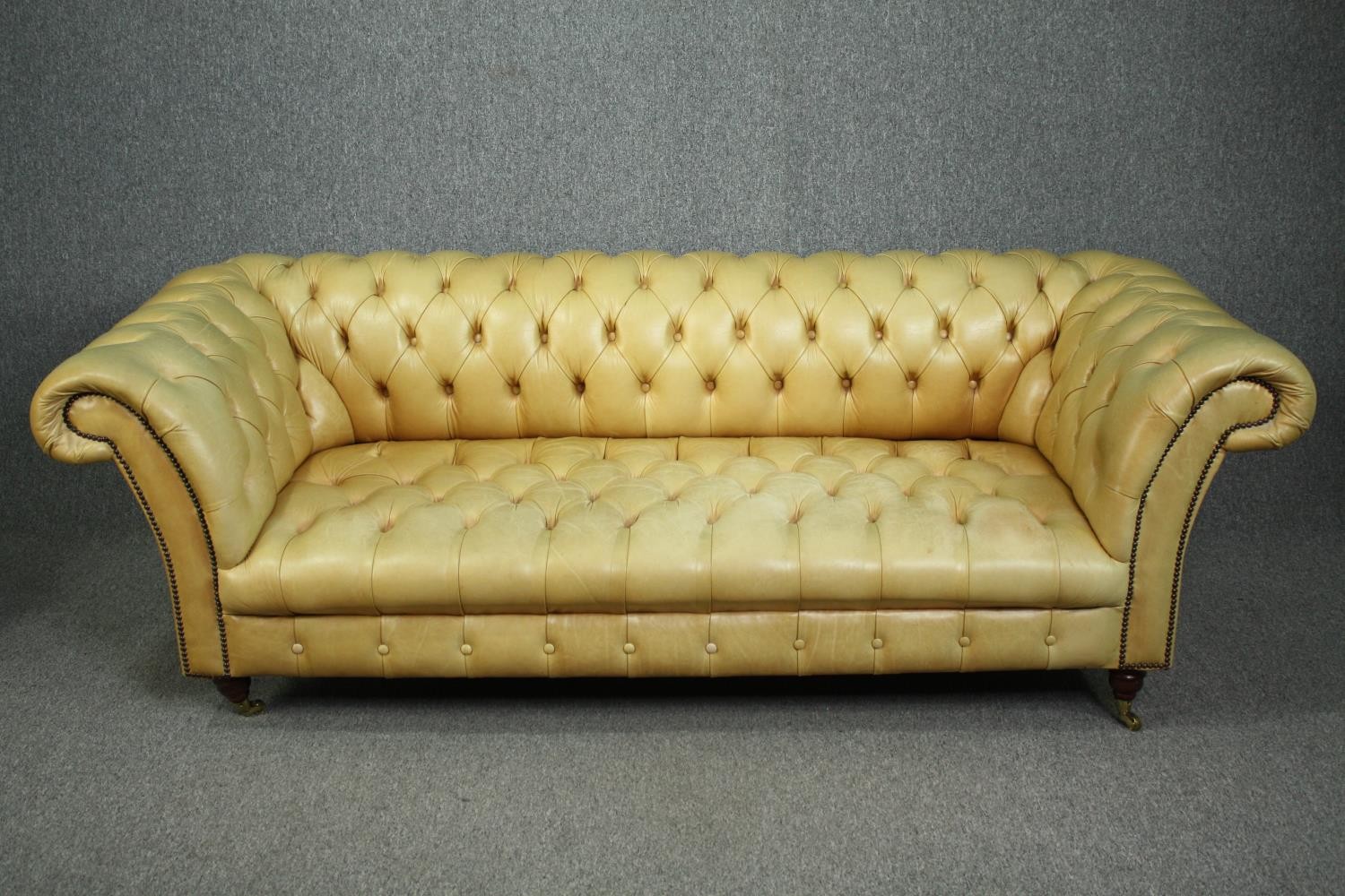 Chesterfield sofa, Victorian style in deep buttoned and studded leather upholstery raised on