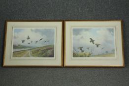 A pair of framed and glazed J C Harrison prints, game birds in flight. H.60 W.70cm. (each)