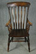 A 19th century beech and elm stick back kitchen armchair. H.114cm.