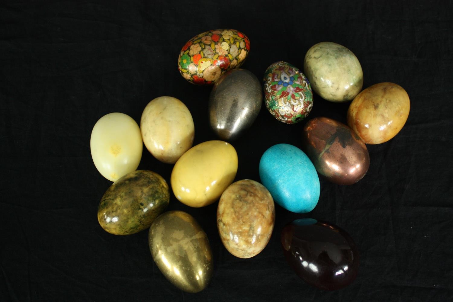 A collection of polished hardstone eggs including two hand decorated. H.7cm. (largest)