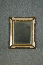 A 19th century wall mirror in glazed and gesso frame with bevelled plate. H.66 W.55cm.