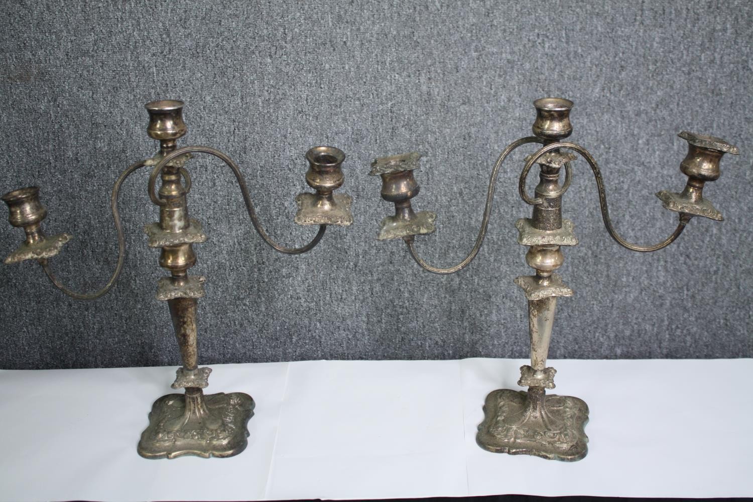 A pair of silver plated three branch table candelabras. H.42cm. (each)
