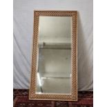 A contemporary carved and lacquered full height mirror. H.200 W.100cm.