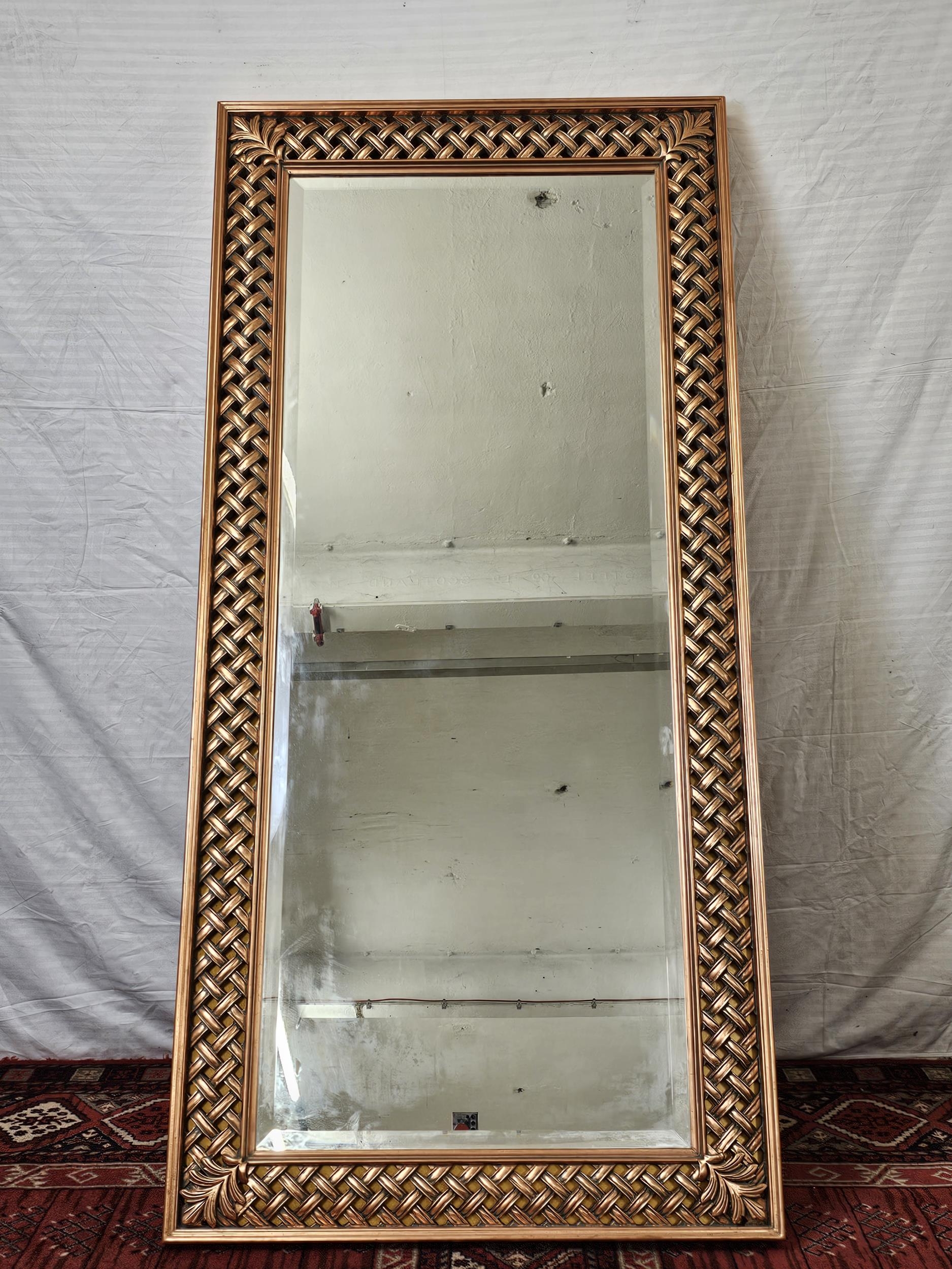 A contemporary carved and lacquered full height mirror. H.190 W.90cm.