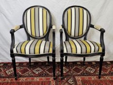 A pair of painted Louis XVI style armchairs.