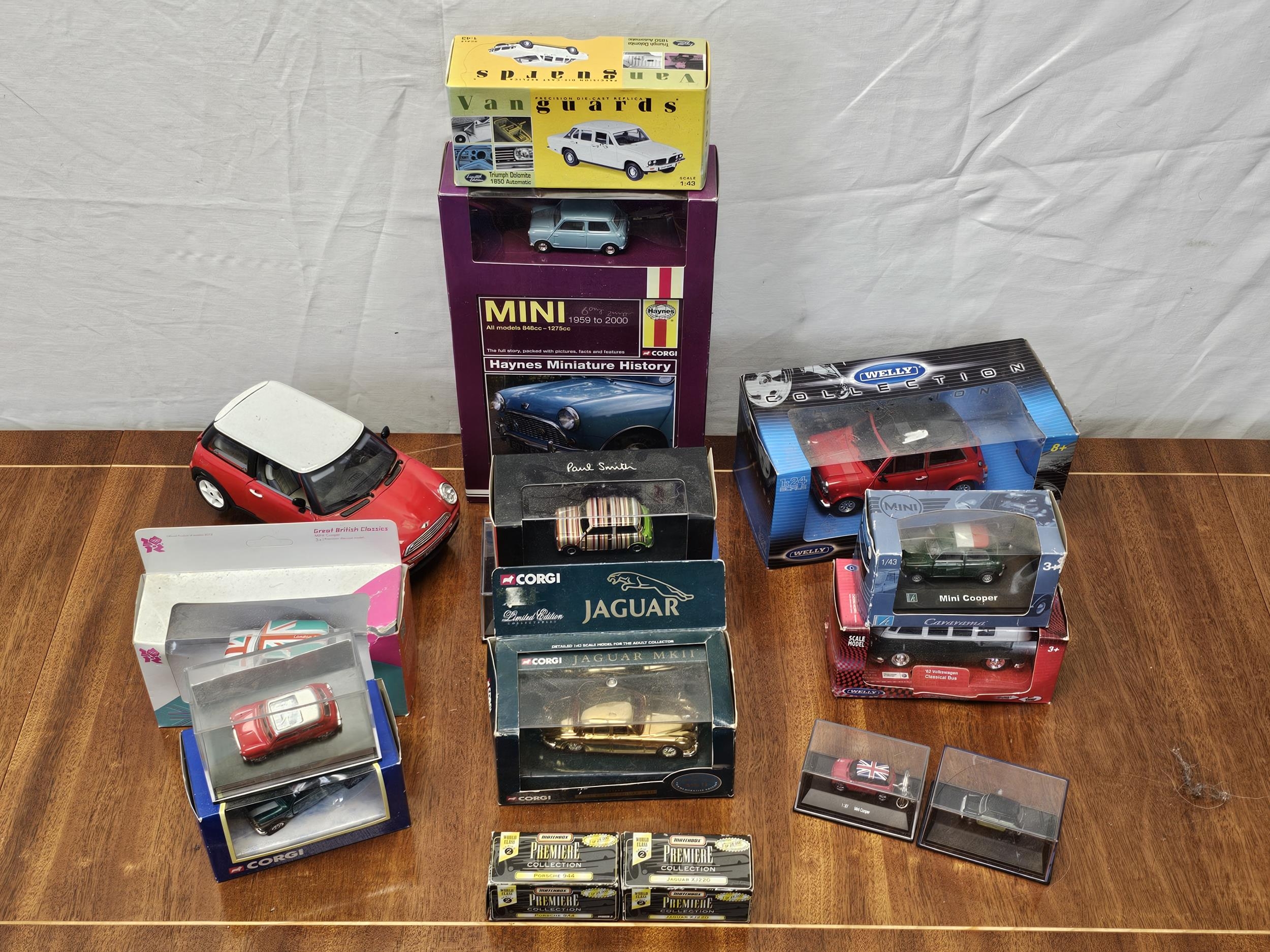 A collection of boxed vintage die-cast cars, Mini Coopers, Jaguar etc