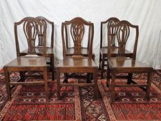 A set of six Georgian oak dining chairs with panel seats. H.93cm.