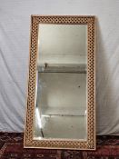 A contemporary carved and lacquered full height mirror, H.200 W.100cm.