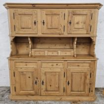 A large contemporary continental style pine dresser in two sections. H.185 W.186 D.52cm.