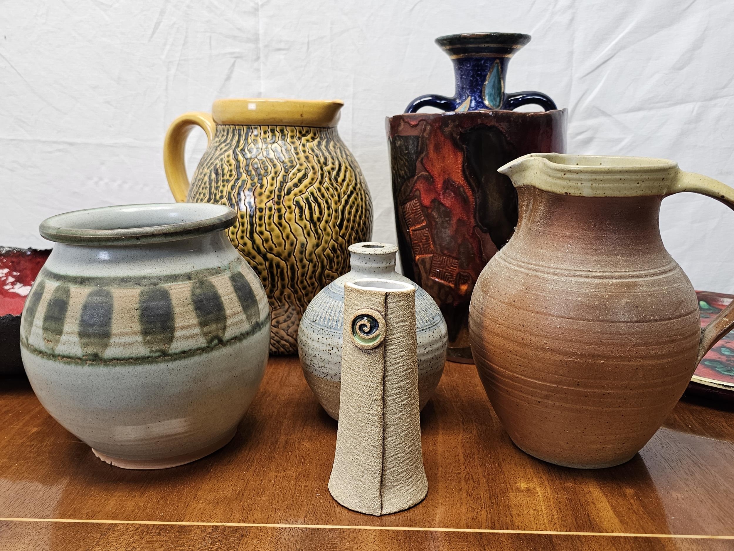 A miscellaneous collection of studio pottery, to include jugs, vases and plates. Tallest vase is - Image 2 of 5