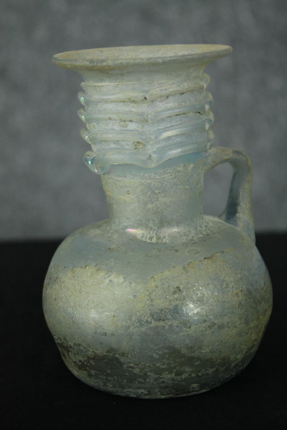 A Roman iridescent glass oil jug. H.12cm. - Image 4 of 8