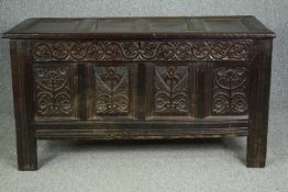 Coffer, 17th century oak with foliate carved panels on stile supports. H.78 W.142 D.62cm.