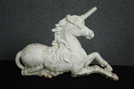 An early 20th century painted cast iron unicorn firedog. H.41 W.60 D.25cm.