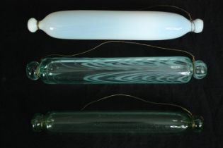 A collection of three 19th century glass rolling pins. L.36cm. (largest).