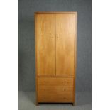 A contemporary hardwood two section wardrobe. H.200 W.85 D.35cm.