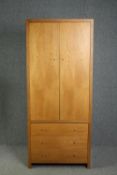 A contemporary hardwood two section wardrobe. H.200 W.85 D.35cm.