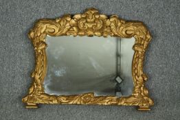 Mantel mirror of small size, 19th century foliate carved giltwood. H.61 W.74cm.