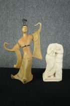 A ceramic dancing Geisha and a carved stone figure. H.31cm. (largest)