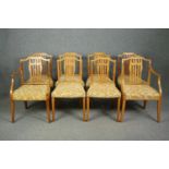 A set of eight Georgian style birch dining chairs to include two carver armchairs. (Repairs to the