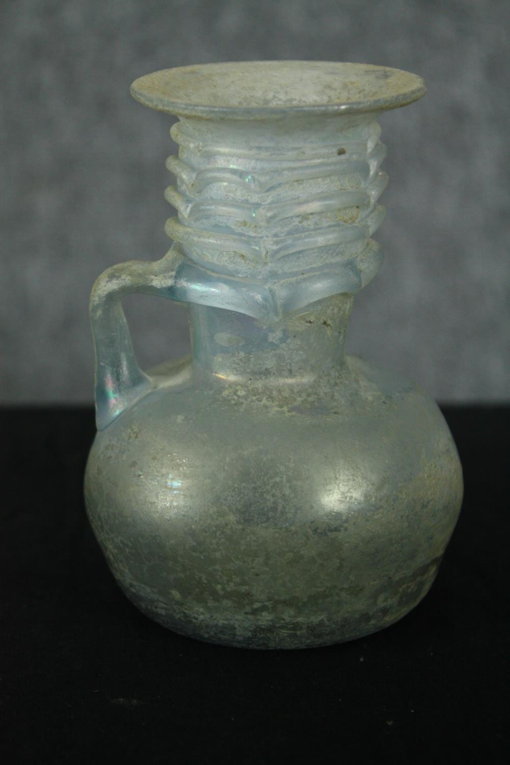 A Roman iridescent glass oil jug. H.12cm. - Image 2 of 8