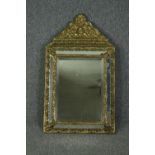 Wall mirror, 19th century Flemish cushion framed with repousse metal cresting and bevelled plate.