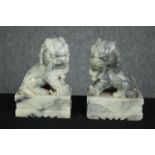 A pair of Chinese carved soapstone foo dogs. H.14cm. (each).