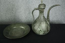 A 19th century Persian bronzed metal ewer with etched foliate and figural design along with a