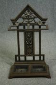 A late 19th century cast iron umbrella stand with twin lift out drip trays. H.80 W.48 D.24cm.