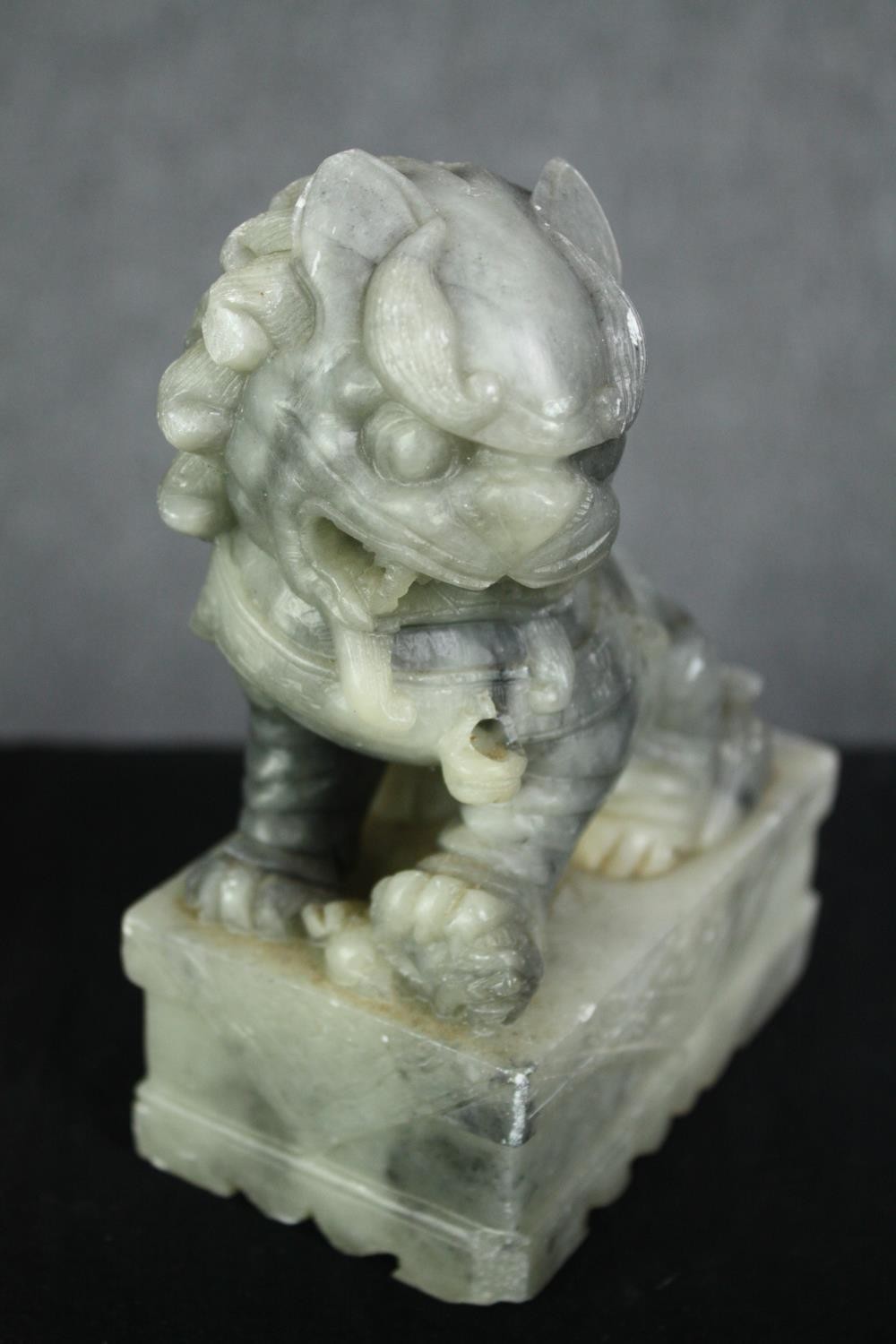 A pair of Chinese carved soapstone foo dogs. H.14cm. (each). - Image 4 of 6