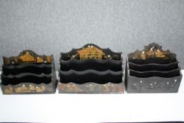 Three vintage lacquered Chinoiserie stationery racks. H.16 W.24 D.10cm. (largest).