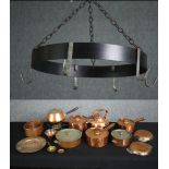 An early 20th century kitchen pot hanger, copper pans and pots and a fondue pan.